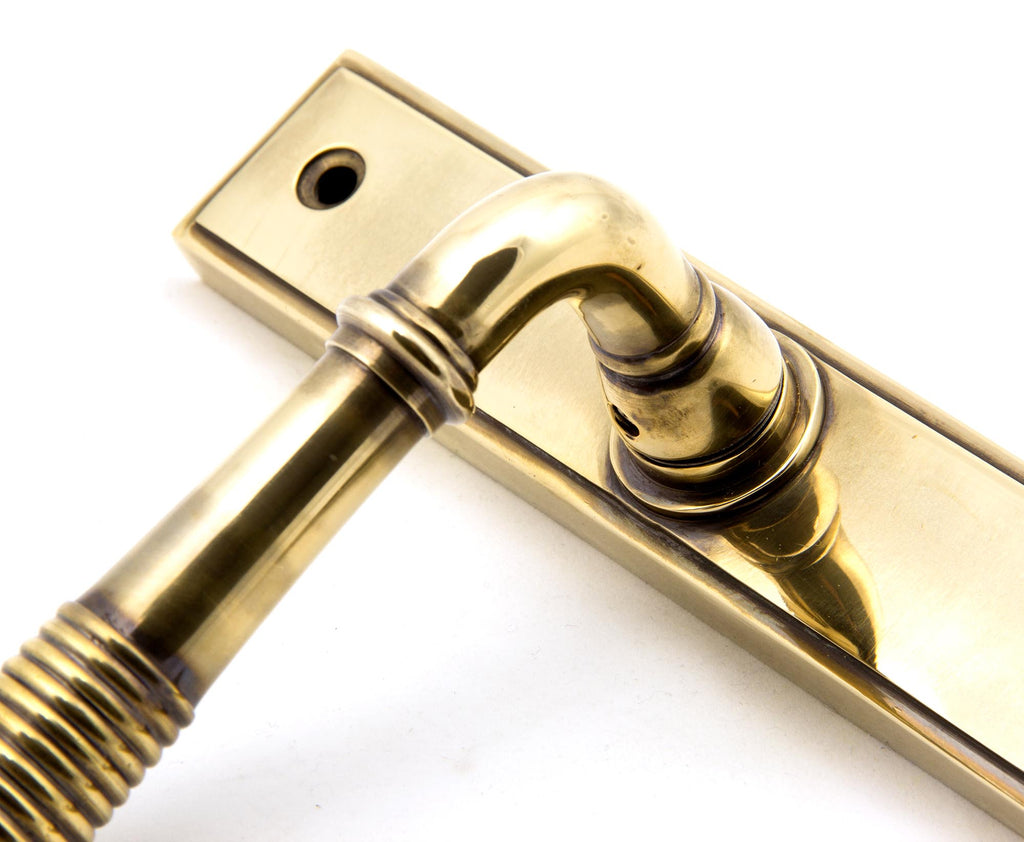 From The Anvil's Aged Brass Reeded Slimline Lever Espag. Lock Set