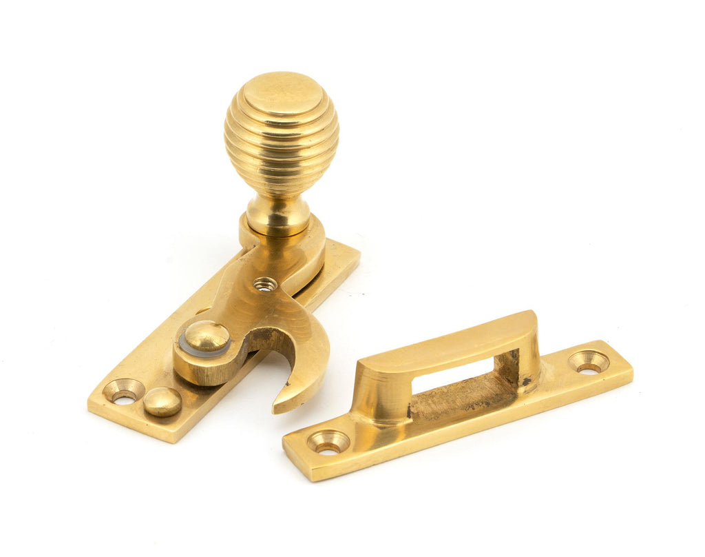 From The Anvil's Polished Brass Beehive Sash Hook Fastener