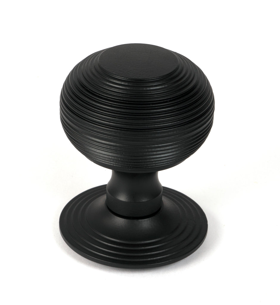 From The Anvil's Matt Black Beehive Centre Door Knob