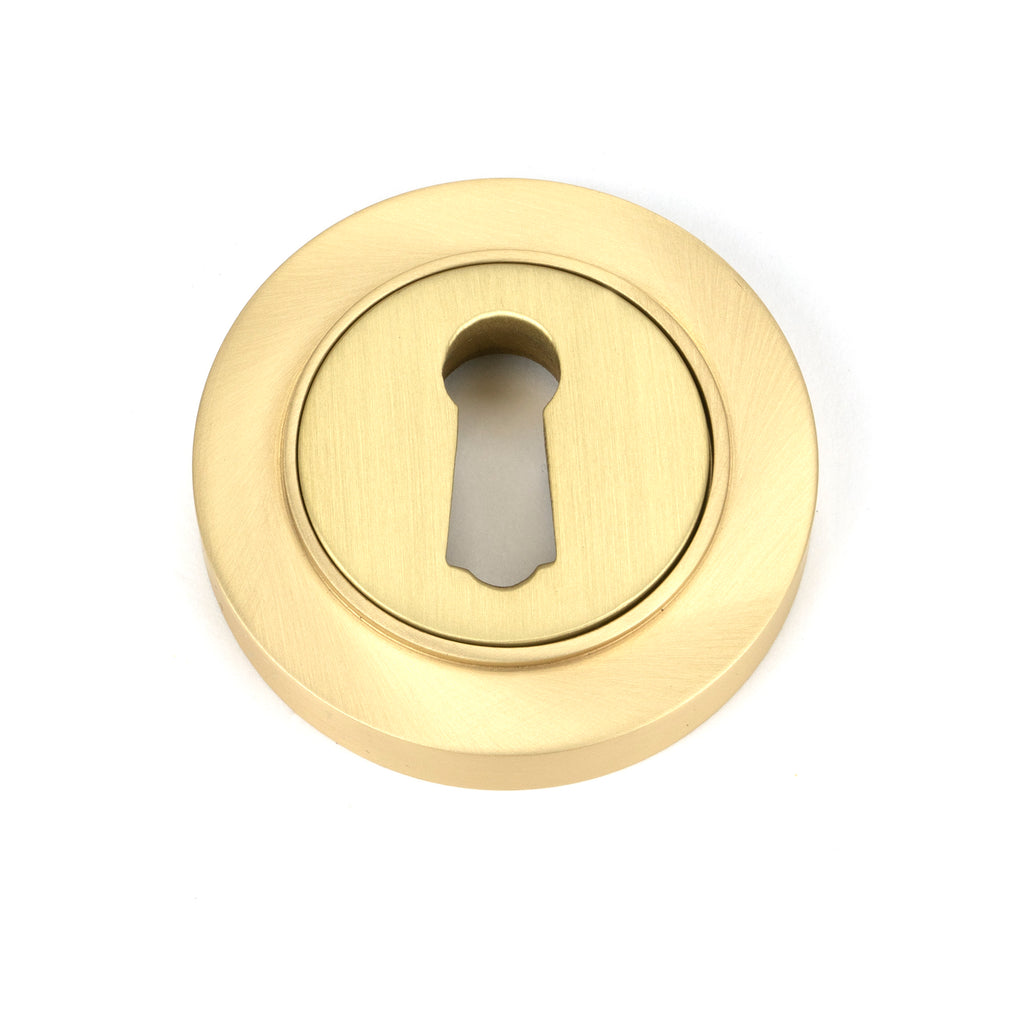 From The Anvil's Satin Brass Round Escutcheon