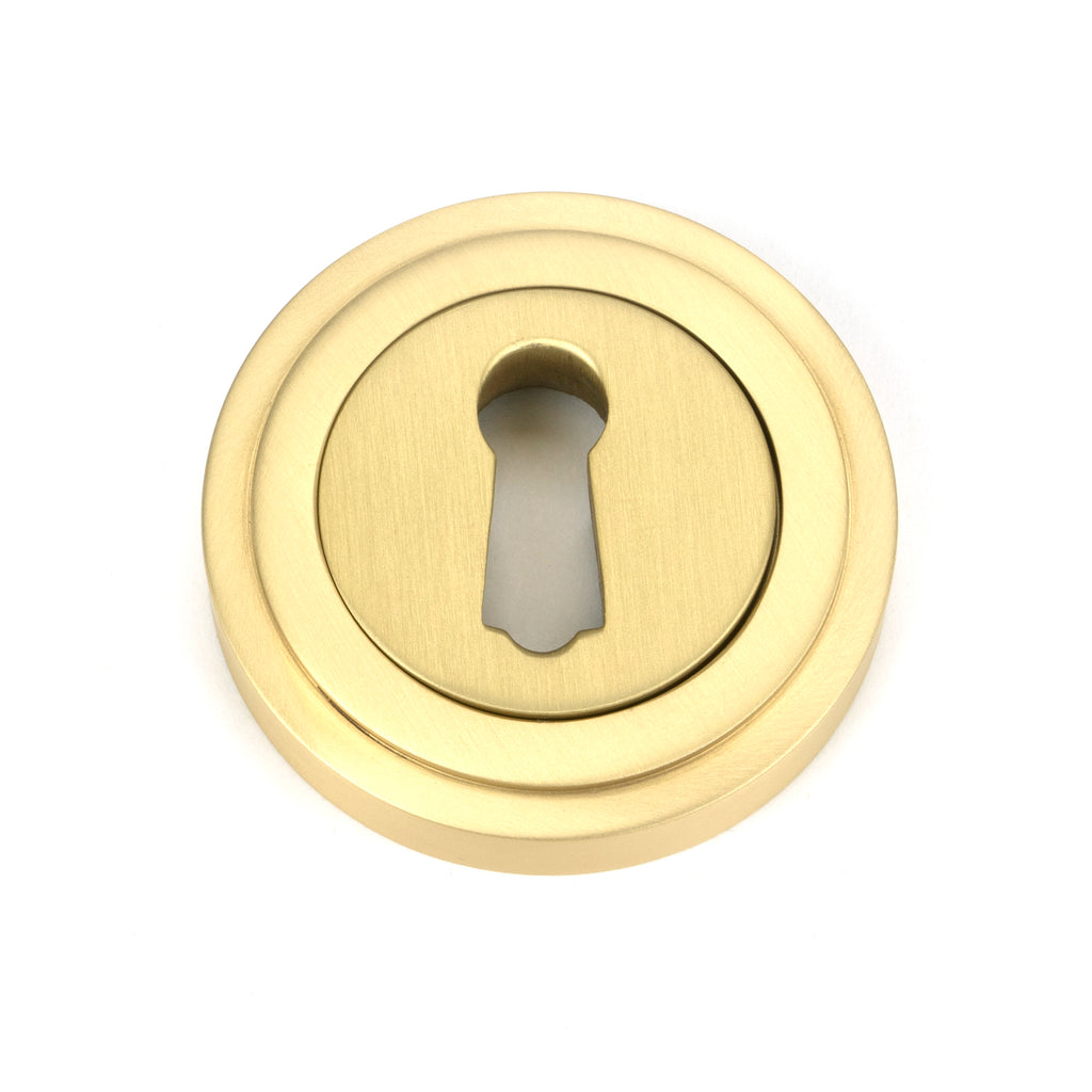 From The Anvil's Satin Brass Round Escutcheon