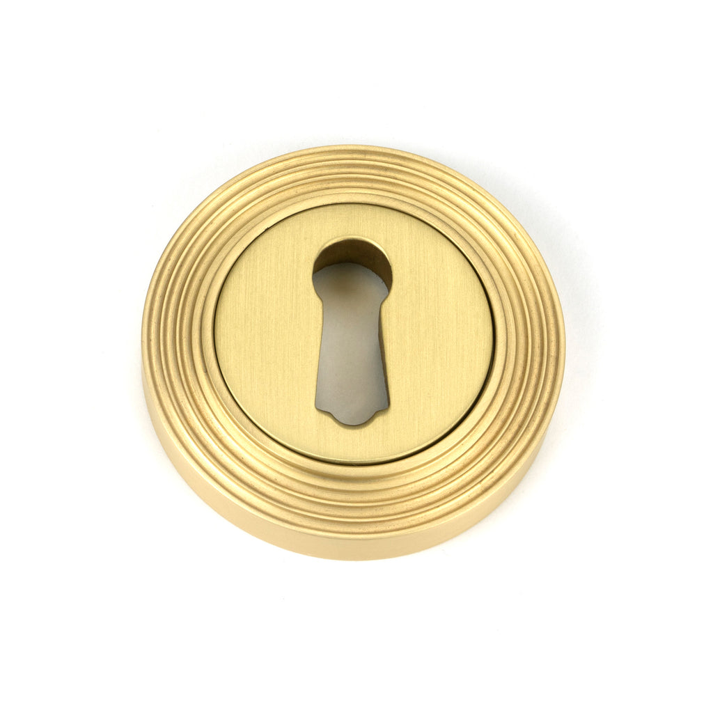 From The Anvil's Satin Brass Round Escutcheon