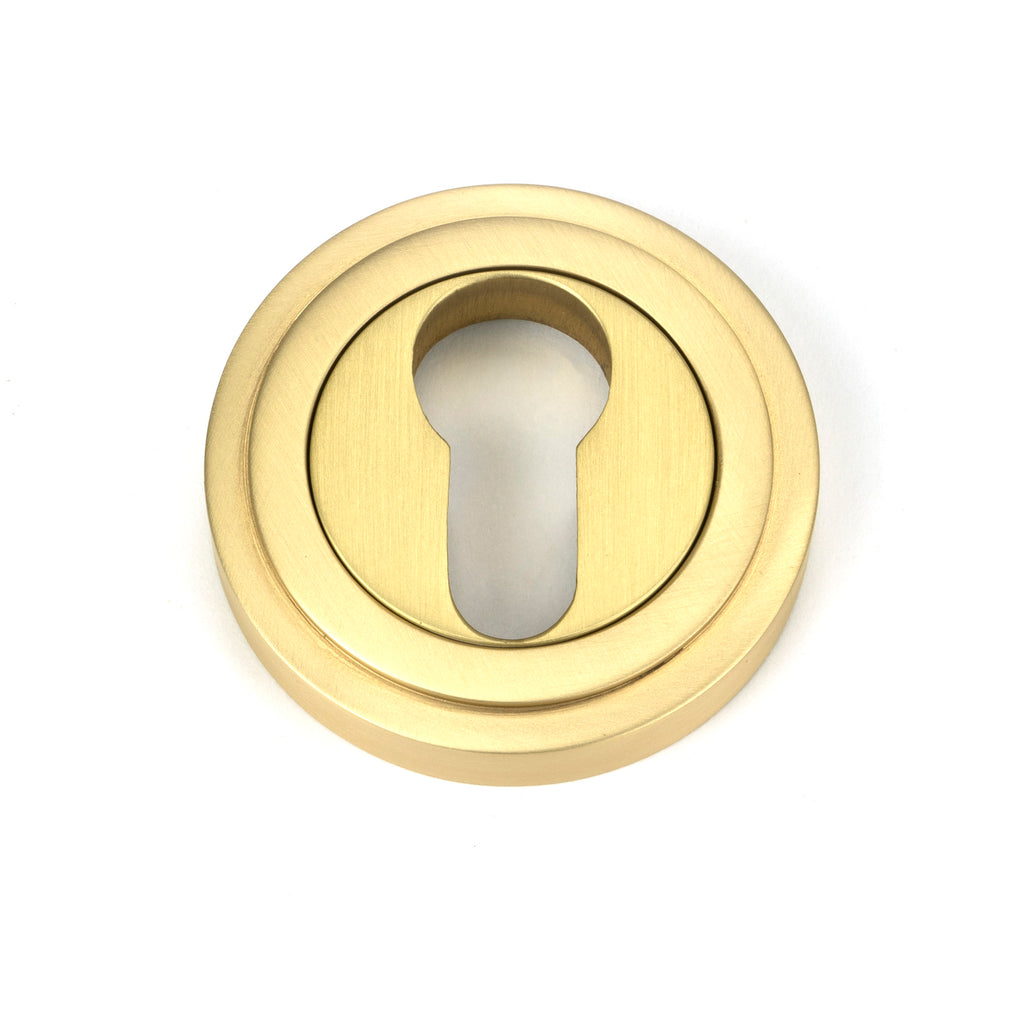 From The Anvil's Satin Brass Round Euro Escutcheon